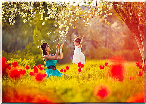 Mother and daughter having fun and playing in the field. 