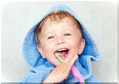 Boy brushing teeth to prevent bottle cavities