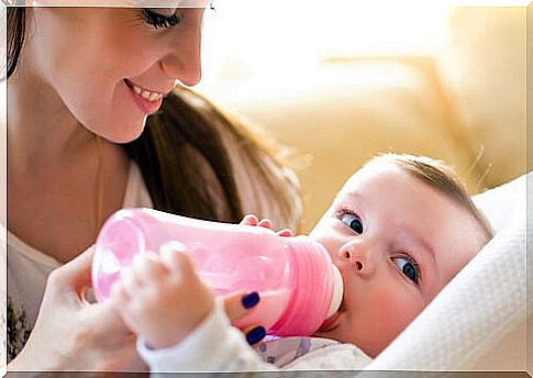 mother giving milk from a bottle to the baby is part of mixed breastfeeding