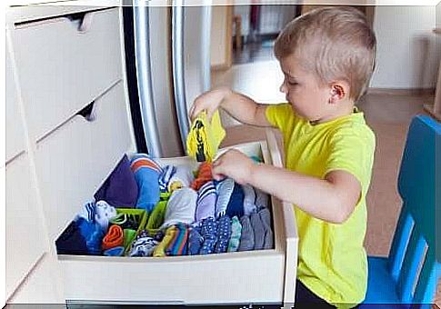 Promoting autonomy in childhood: a boy putting his clothes back