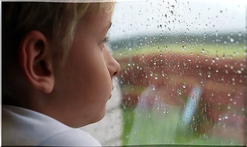 Boy looking out the window thinking about suicide.