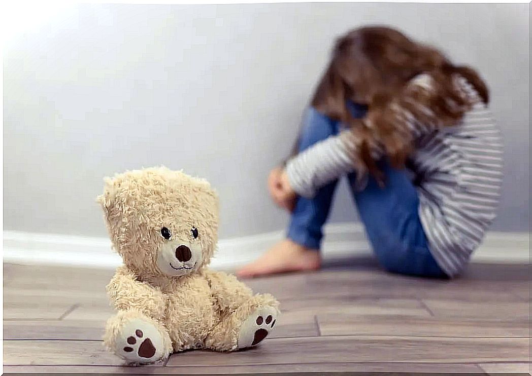 Very sad girl with a teddy bear while thinking about suicide.