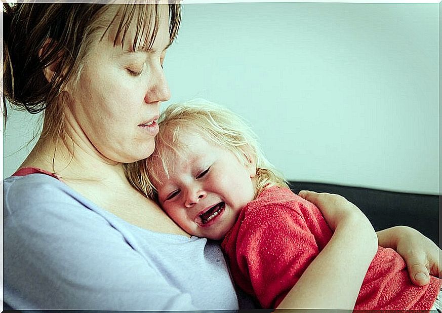 mother hugs baby crying